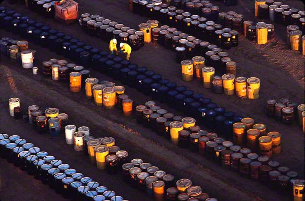 aerial-of-men-counting-barrels-at-a-toxic-waste-facility-horizontal_DM