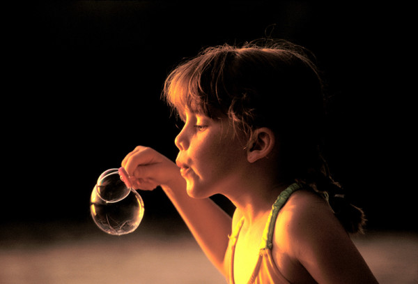 girl blowing bubbles