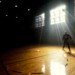 man standing with basketball in gym thumbnail