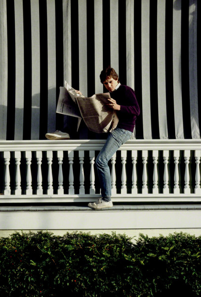 guyreadingpaperonporch