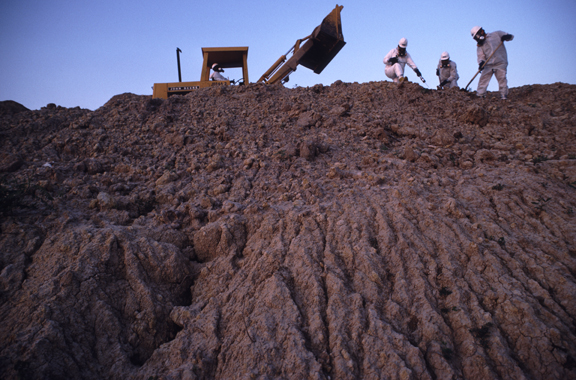 men working at a toxic waste site