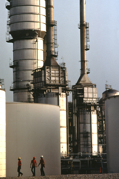 three men walking in petrochemical plant 0076