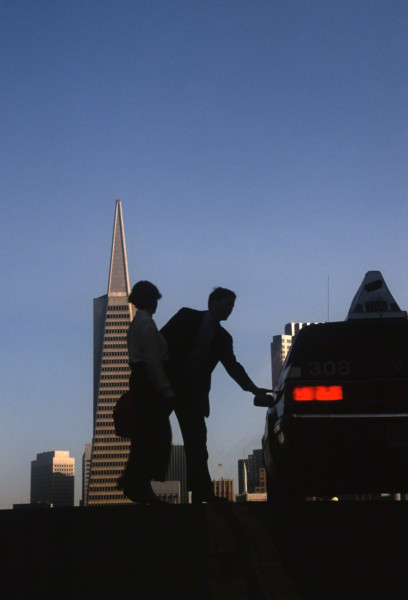 people getting into cab with transamerica bldg in background