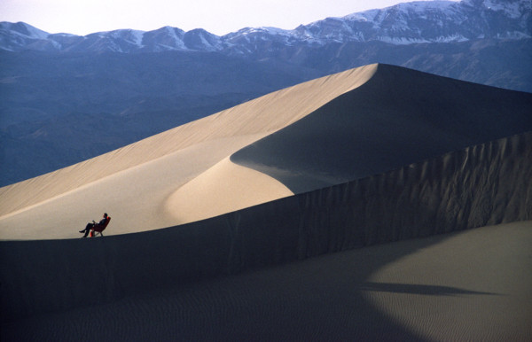 man in first class chair in sand dune