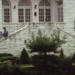 student reading in front of limestone building thumbnail