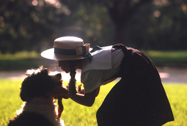 silhouette of girl kissing dogDM