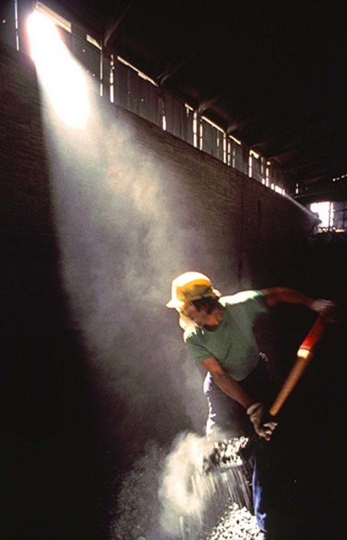 worker-shoveling-as-the-sun-shines-through-a-window