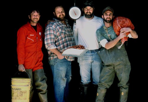 Standing just inside the building.